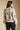 Back view of a woman wearing the Saltwater Luxe Ronnie Sweater on a neutral background with pants
