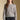 Front view of a woman wearing the Saltwater Luxe Saskia Sweater on a neutral background with jeans
