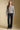A full body front view of a woman wearing the Saltwater Luxe Saskia Sweater on a neutral background