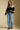 A full body front view of a woman wearing the Saltwater Luxe Scarlit Sweater on a neutral background
