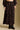 Front view of a woman wearing the Saltwater Luxe Selah Midi Skirt on a neutral background with hands at sides and matching top