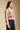 Side angle view of a woman wearing the Saltwater Luxe Slaide Sweater on a neutral background