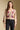 Front view of a woman wearing the Saltwater Luxe Slaide Sweater on a neutral background with black jeans