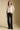 A full body front view of a woman wearing the Saltwater Luxe Stacia Top on a neutral background