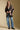 A full body front view of a woman wearing the Saltwater Luxe Stari Sweater on a neutral background