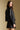 Back view of a woman wearing the Saltwater Luxe Sylvie Jacket and skirt on a neutral background