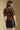 Back view of a woman wearing the Saltwater Luxe Tachi Top on a neutral background with skirt