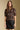 Front view of a woman wearing the Saltwater Luxe Tachi Top on a neutral background with Ralie faux leather skirt