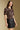 Front view of a woman wearing the Saltwater Luxe Tachi Top on a neutral background with Ralie skirt