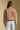 Back view of a woman wearing the Saltwater Luxe Tamira Jacket on a neutral background with arms at sides