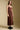 Side angle view of a woman wearing the Saltwater Luxe Tarynel Maxi Dress on a neutral background with shoes