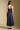 Back view of a woman wearing the Saltwater Luxe Tarynel Maxi Dress on a neutral background