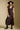 Front view of a woman wearing the Saltwater Luxe Tayler Midi Dress on a neutral background with shoes and hat