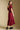 A full body back view of a woman wearing the Saltwater Luxe Tish Midi Dress on a neutral background