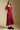 Side angle view of a woman wearing the Saltwater Luxe Tish Midi Dress on a neutral background with hands in pockets