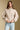 Front view of a woman wearing the Saltwater Luxe Tovie Jacket on a neutral background with hands at waist