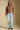 A full body front view of a woman wearing the Saltwater Luxe Tovie Jacket on a neutral background
