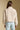 Back view of a woman wearing the Saltwater Luxe Tovie Jacket on a neutral background with jeans