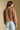 Back view of a woman wearing the Saltwater Luxe Tovie Jacket on a neutral background with arms at sides