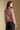 Back view of a woman wearing the Saltwater Luxe  Verity Sweater on a neutral background with arms at sides