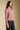 Side angle view of a woman wearing the Saltwater Luxe Verity Sweater on a neutral background with pants