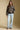 A full body front view of a woman wearing the Saltwater Luxe Vincent Sweater on a neutral background