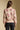 Back view of a woman wearing the floral Saltwater Luxe Vincent Sweater on a neutral background