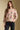 Front view of a woman wearing the floral Saltwater Luxe Vincent Sweater on a neutral background with arms lowered
