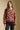 Front view of a woman wearing the floral Saltwater Luxe Vincent Sweater on a neutral background with arms lowered