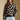 Front view of a woman wearing the floral Saltwater Luxe Vincent Sweater on a neutral background with arms lowered
