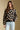 Front view of a woman wearing the floral Saltwater Luxe Vincent Sweater on a neutral background with arms lowered