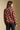 Back view of a woman wearing the floral Saltwater Luxe Vincent Sweater on a neutral background
