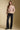 A full body front view of a woman wearing the Saltwater Luxe Vincent Sweater on a neutral background