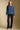 A full body front view of a woman wearing the Saltwater Luxe Xenia Sweater on a neutral background
