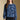 Front view of a woman wearing the Saltwater Luxe Xenia Sweater on a neutral background with black pants