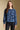 Front view of a woman wearing the Saltwater Luxe Xenia Sweater on a neutral background with black pants