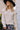 Front view of a woman wearing the Saltwater Luxe  Jeri Sweater in an outdoor setting