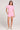 A full body front view of a woman wearing the Saltwater Luxe Short Sleeve Petunia Pullover on a neutral background