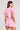 Back view of a woman wearing the Saltwater Luxe Short Sleeve Petunia Pullover on a neutral background