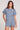 Front view of a woman wearing the Saltwater Luxe Short Sleeve Worn Blue Pullover on a neutral background