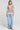 A full body front view of a woman wearing the Saltwater Luxe Siera Natural Top on a neutral background