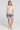 A full body front view of a woman wearing the Saltwater Luxe Siera Top in Sunglow on a neutral background