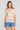 Front view of a woman wearing the Saltwater Luxe Siera Top in Sunglow on a neutral background