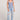 Full body front view of a woman wearing the Saltwater Luxe Slim Worn Blue Tank on a neutral background