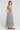 Back view of a woman wearing the Saltwater Luxe Stein Midi Dress on a neutral background