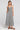 Front view of a woman wearing the Saltwater Luxe Stein Midi Dress on a neutral background