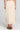 Back view of a woman wearing the Saltwater Luxe Suzi Midi Skirt in Natural on a neutral background