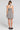 Back view of a woman wearing the Saltwater Luxe Sydney Mini Dress on a neutral background