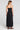Back view of a woman wearing the Saltwater Luxe Tarynnia Black Maxi Dress on a neutral background
