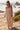 Front view of a woman wearing the Saltwater Luxe Taytum Maxi Dress on a beach